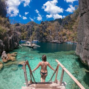 Scenic island cove with clear waters and limestone cliffs in the Philippines.