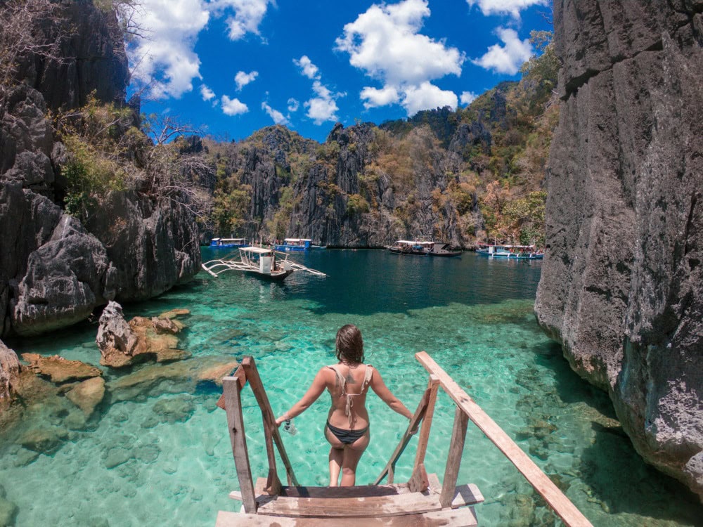 Scenic island cove with clear waters and limestone cliffs in the Philippines.