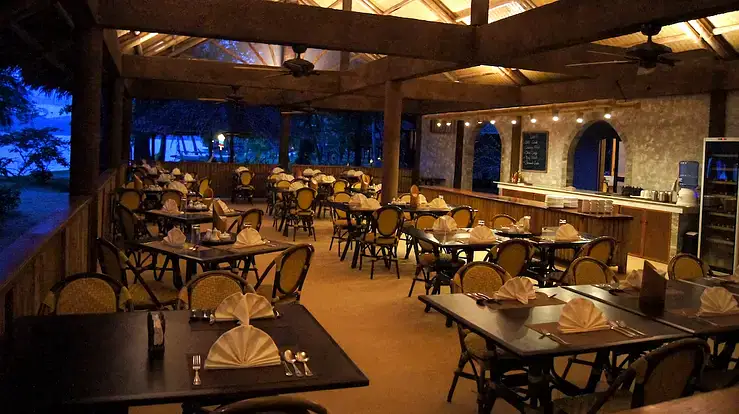 Al fresco restaurant in the Philippines with elegant table settings and tropical ambiance.