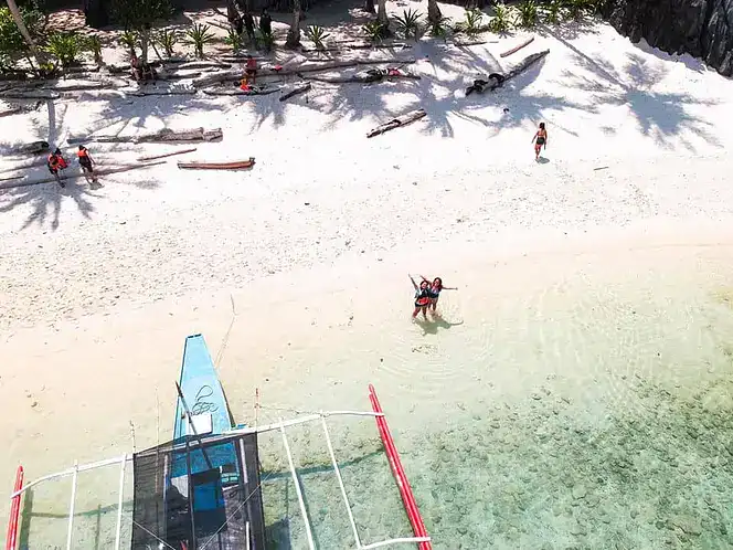Snorkelers enjoying the clear waters and white sandy beaches in the Philippines.