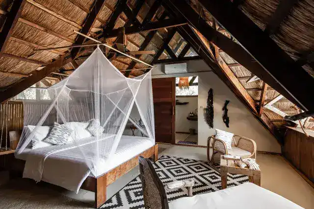 Comfortable bedroom with mosquito net in a tropical-style villa.