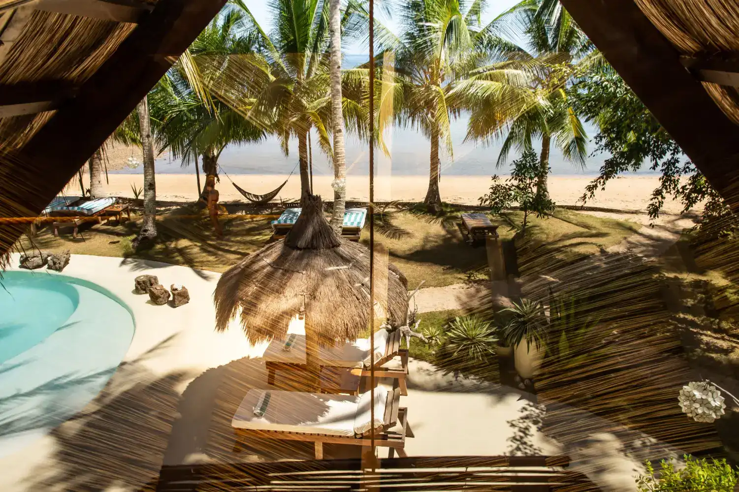 Sunbathing and relaxing on a beach in the Philippines with palm trees and clear waters.