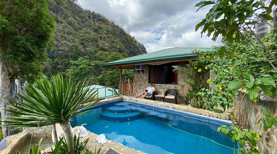 Stunning mountain views surround a private pool at a cozy Philippines island house. Perfect for relaxation in nature.