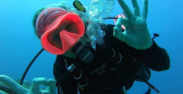 Vibrant underwater diver snorkeling in crystal-clear waters, highlighting adventure travel in the Philippines.