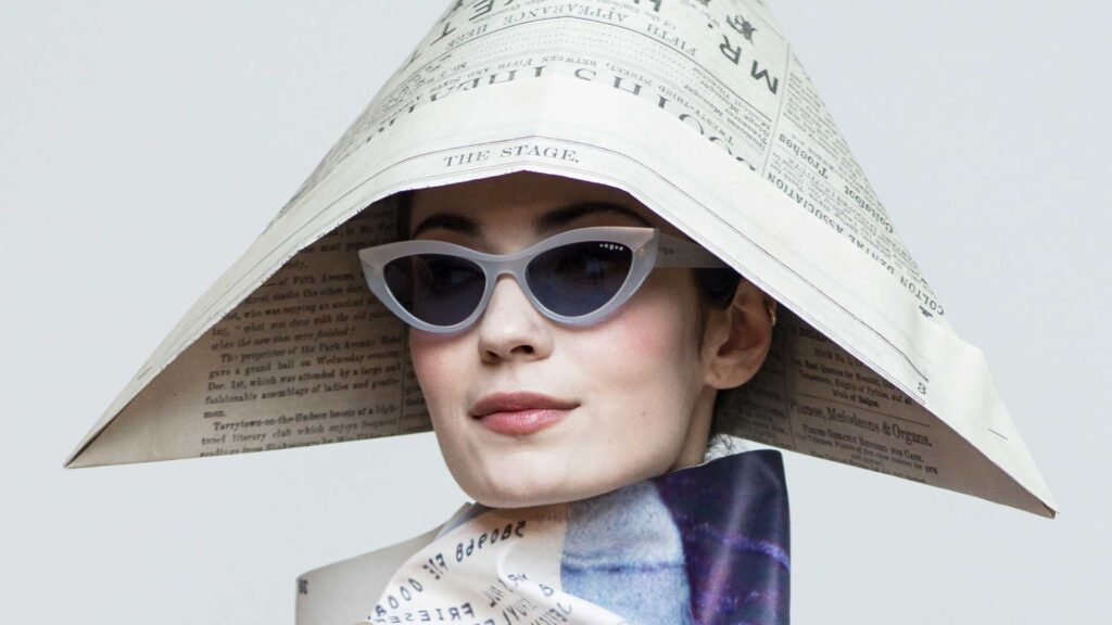 a woman with a hat and sunglasses on her head