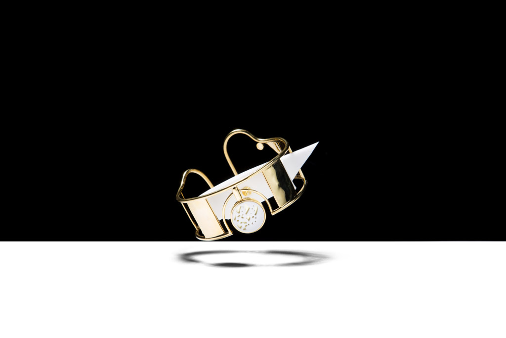 a gold ring with a knife sticking out of it