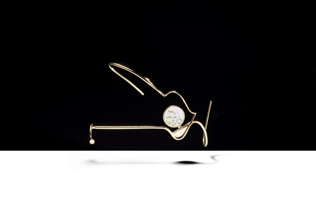 a white clock sitting on top of a black surface