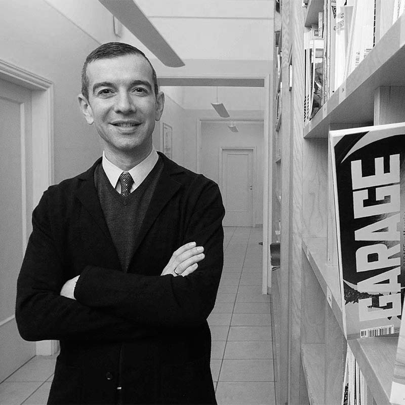 a man in a suit and tie standing in a hallway