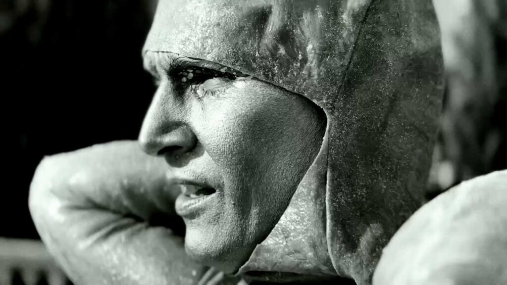 a black and white photo of a woman wearing a helmet