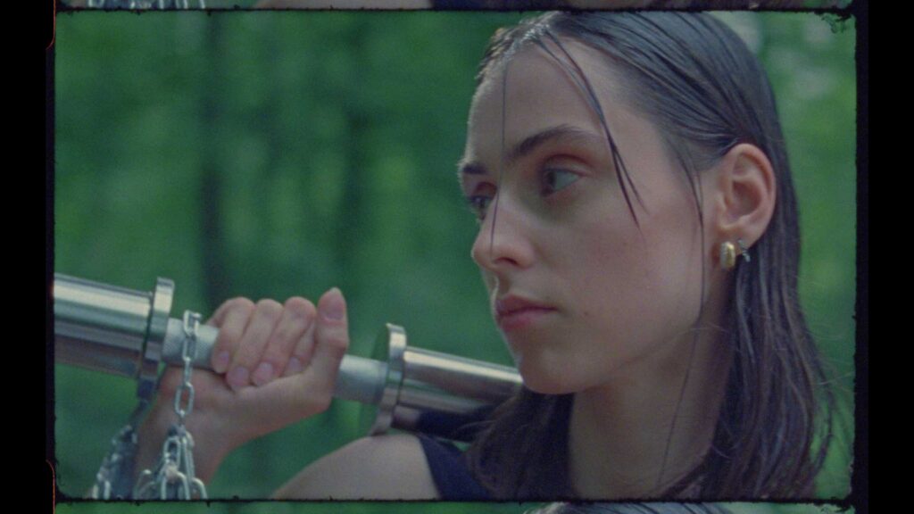 a woman holding a sword in front of her face