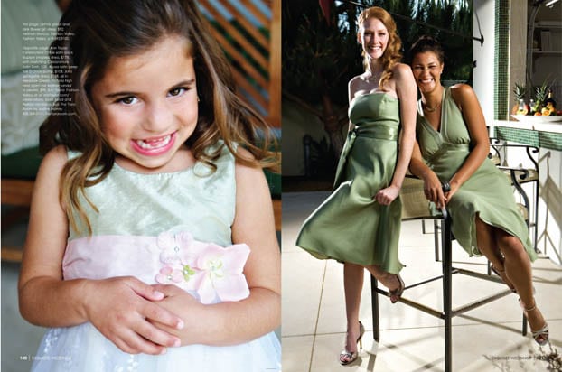 A young girl in a pale green and white dress smiles at the camera; beside her, two women in light green dresses, reminiscent of an Exquisite Weddings Magazine feature, sit and stand, smiling brightly in a sunlit indoor space.