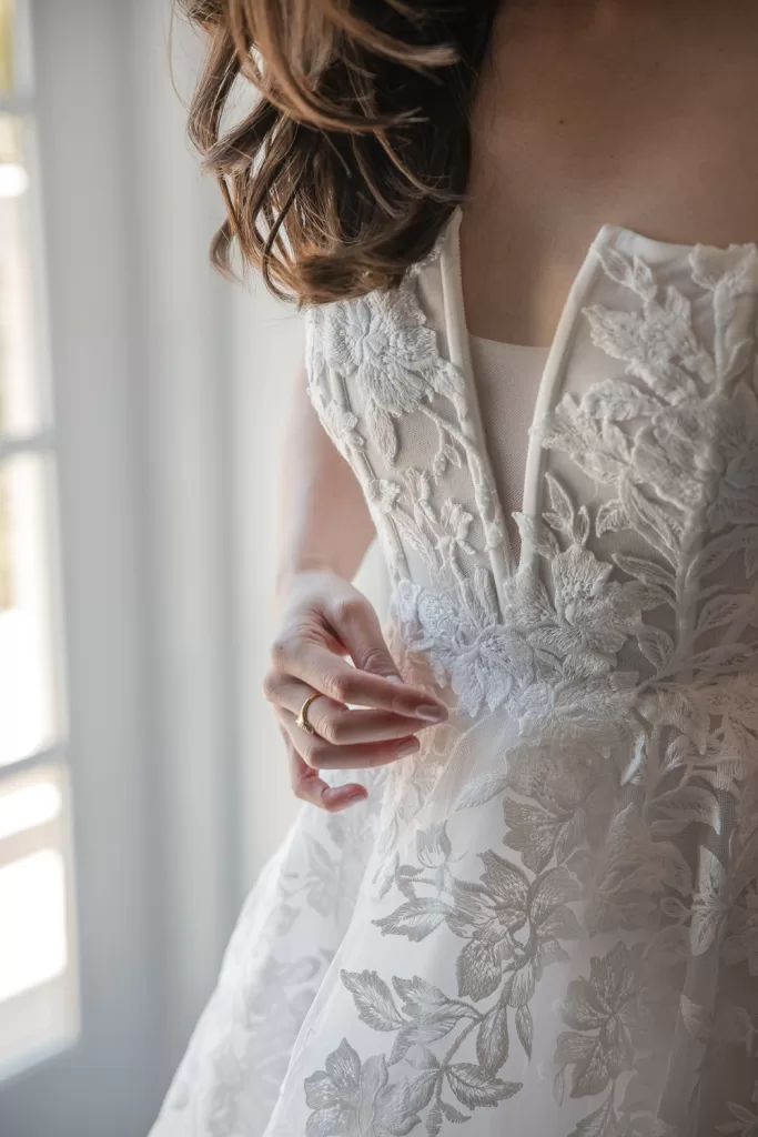 detail of lace white wedding dress with plunging neckline