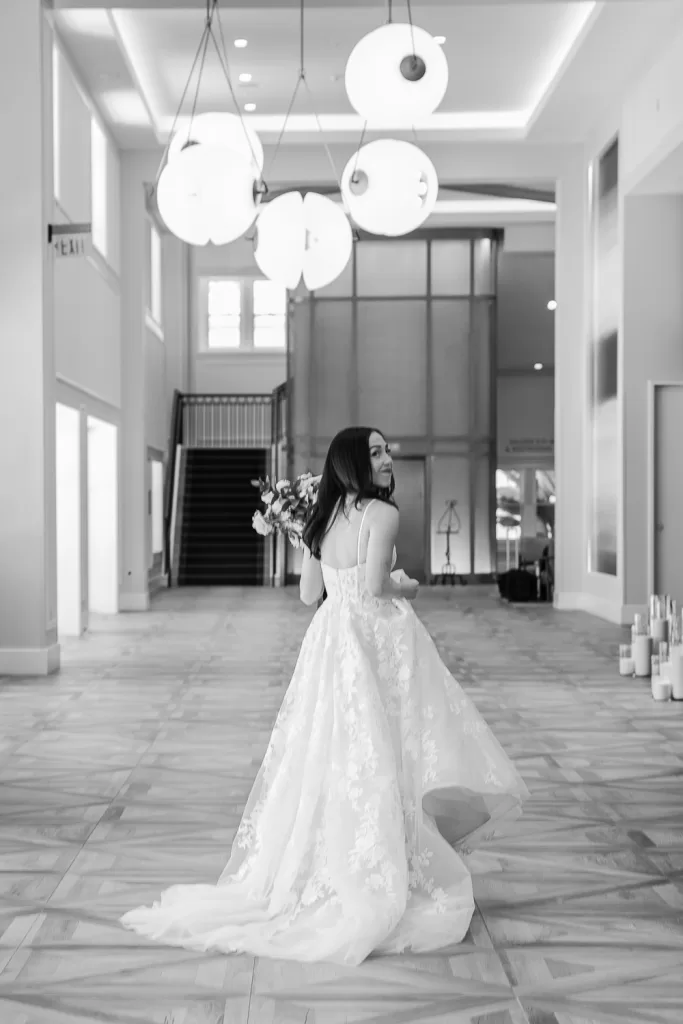 bride walking away shown in black and white inside the southpointe event center, coronado