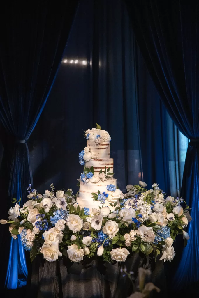 Southpointe ballroom floral installation around naked wedding cake of white garden roses and blue hydrangea