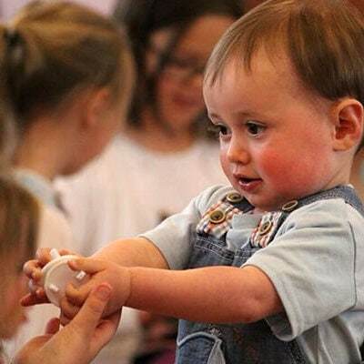 A baby holding something in its hands.