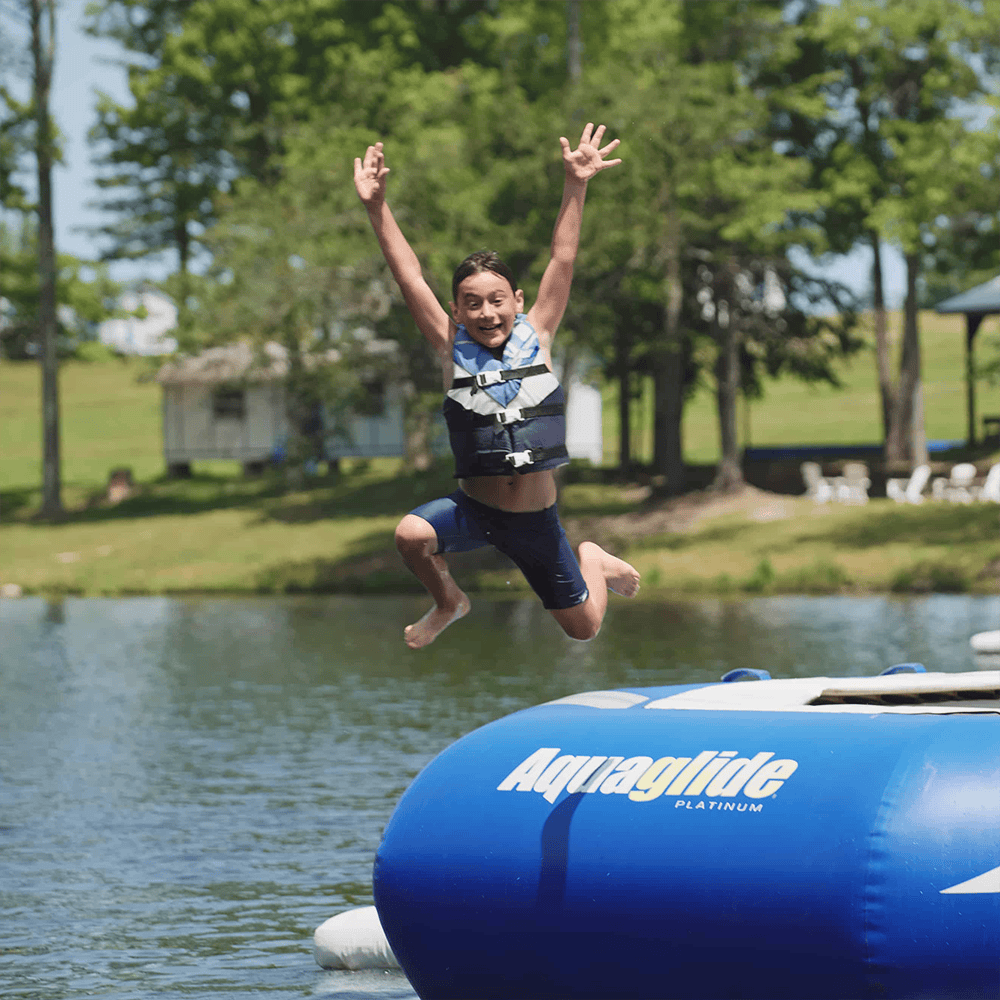 One Happy Camper jumping into the lake