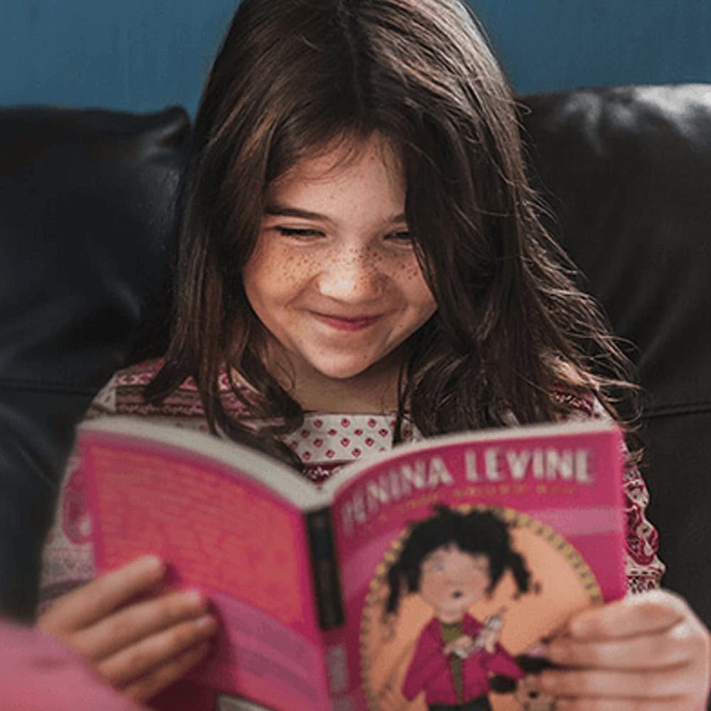PJ Library young girl reading book