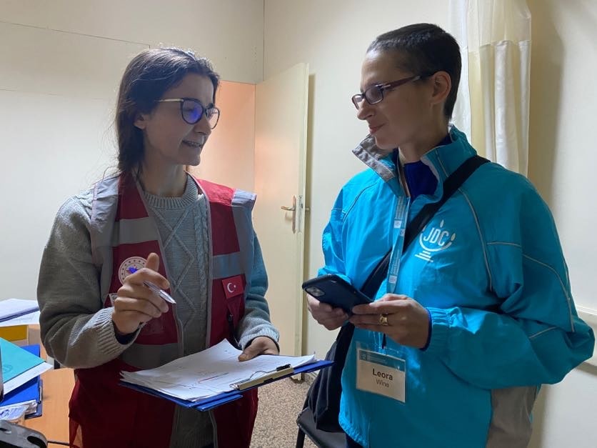 JDC staff person with volunteer and clipboard