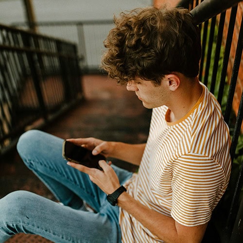 person texting on the stairs