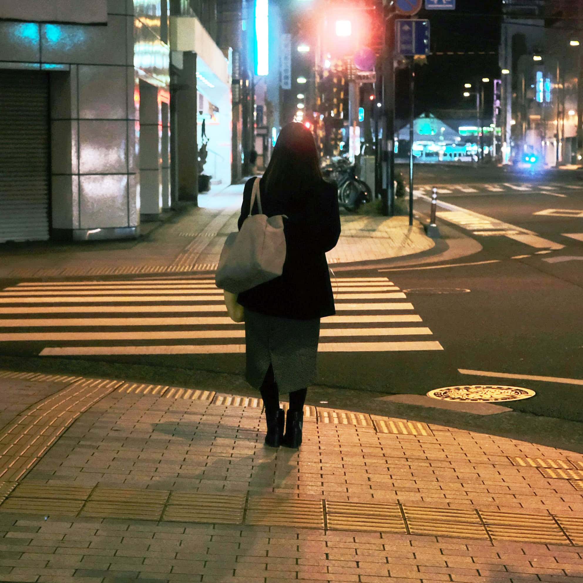woman alone at night on city street