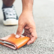 Person picking up a lost wallet