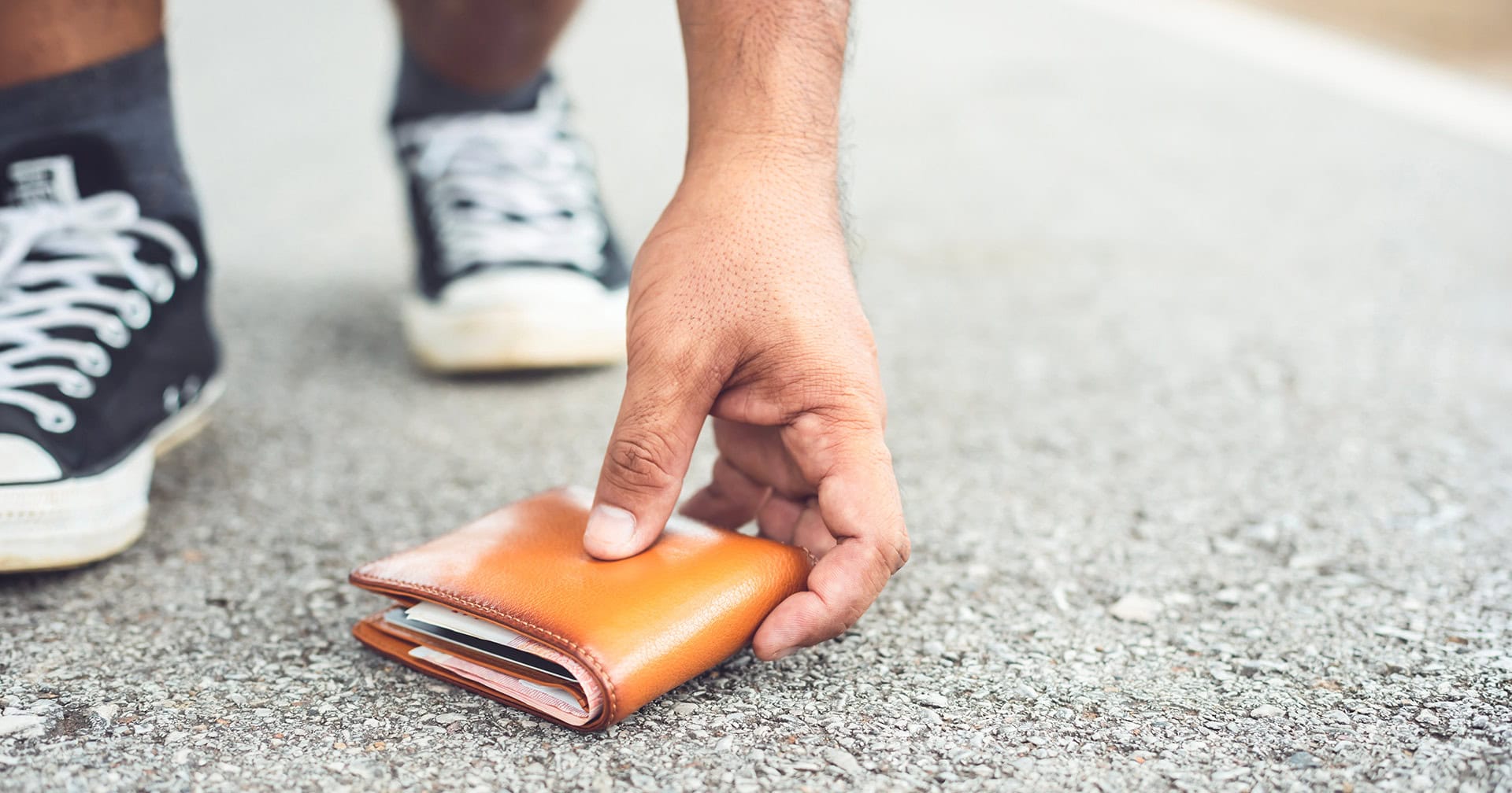 Person picking up a lost wallet