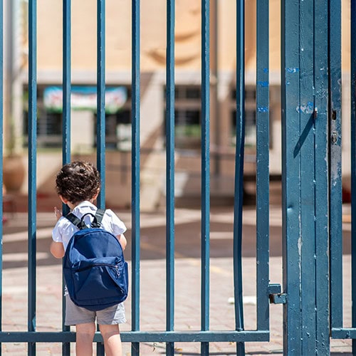 child looking through gate