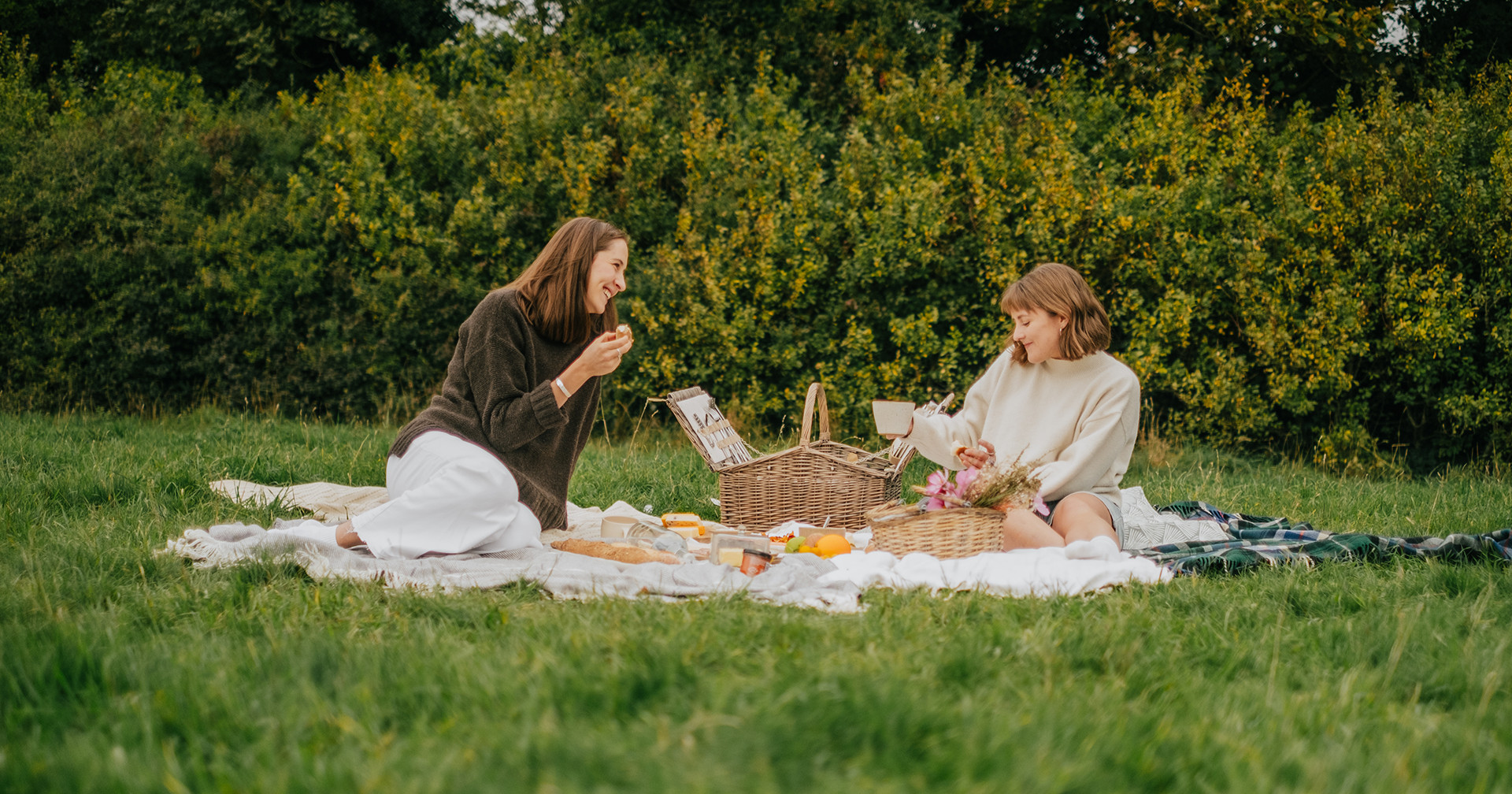 women on a picnic blanket