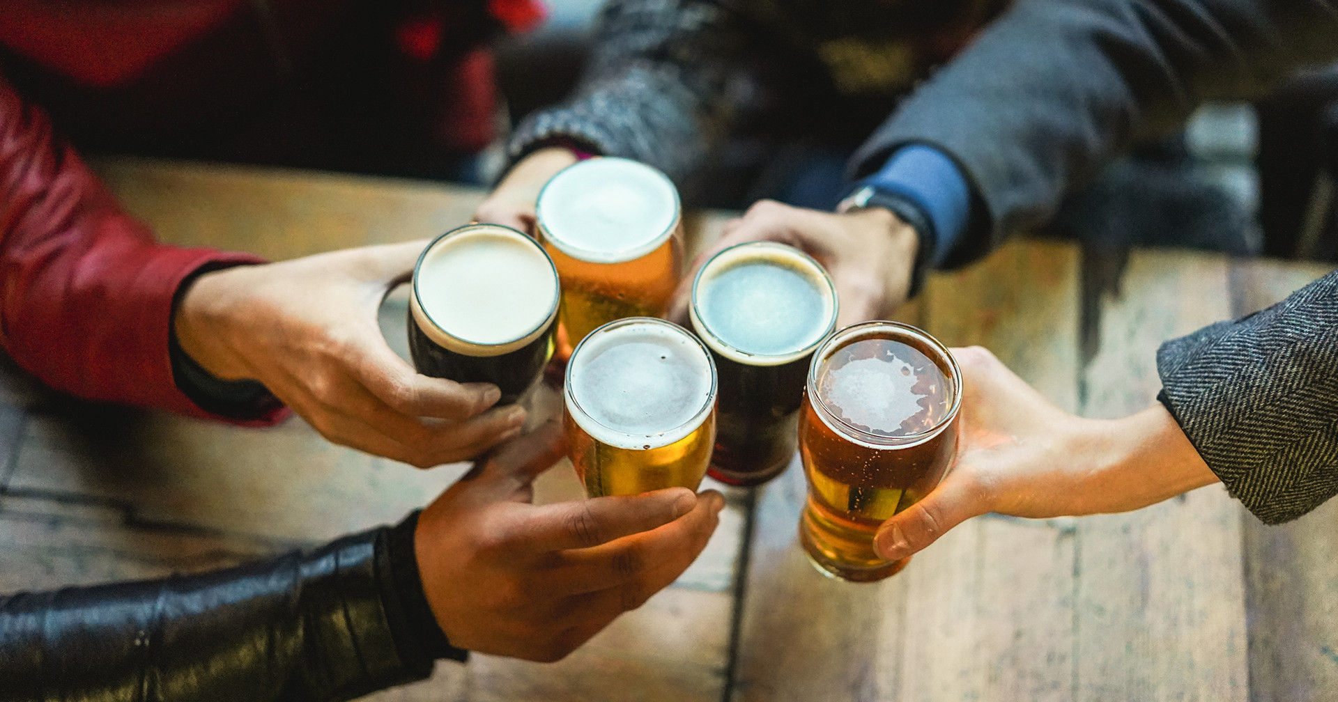people toasting with beer
