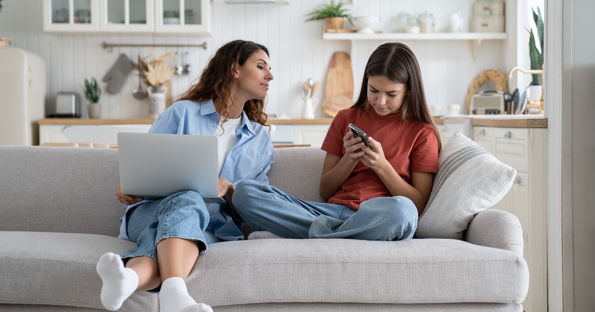 Mother and daughter on digital devices