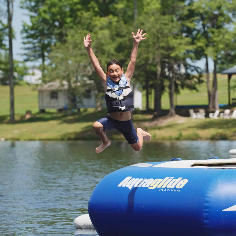 One Happy Camper jumping into the lake