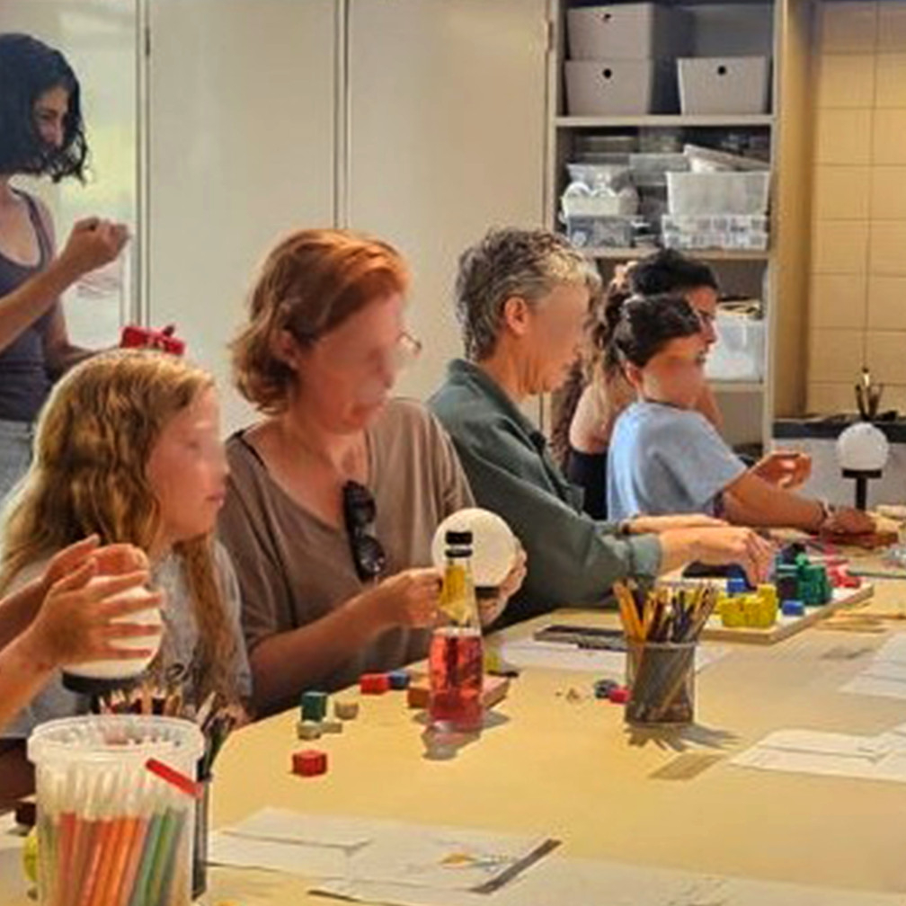 A group of kids and adults participating in art therapy