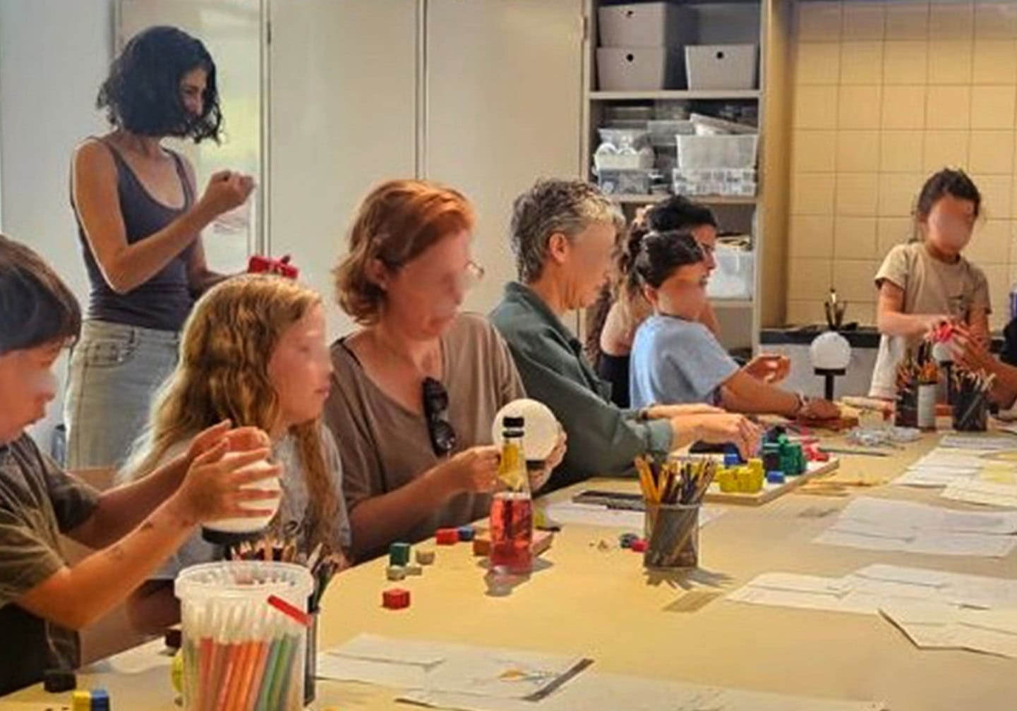 A group of kids and adults participating in art therapy