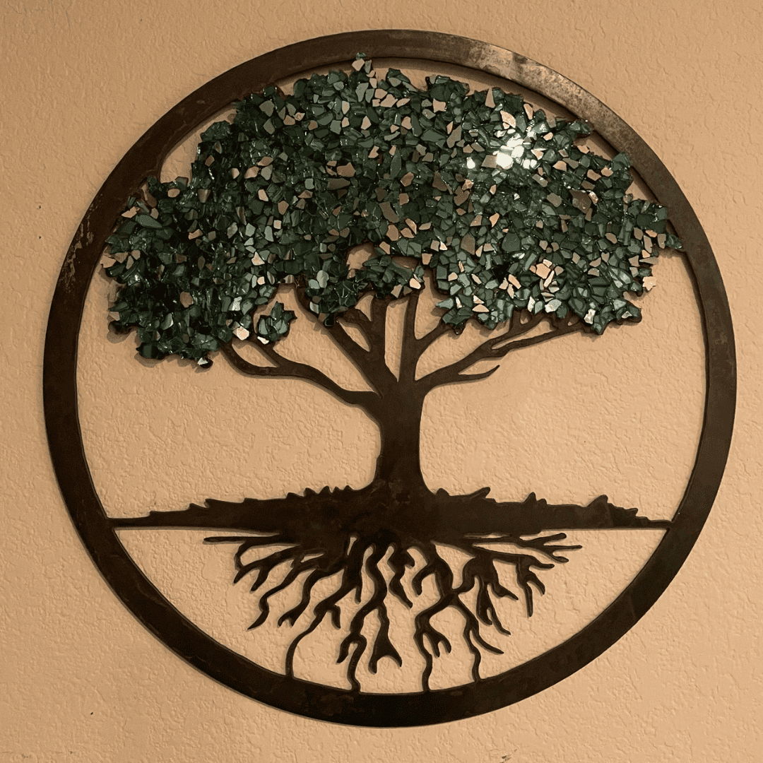 Decorative metal wall art of a tree with roots and leaves.