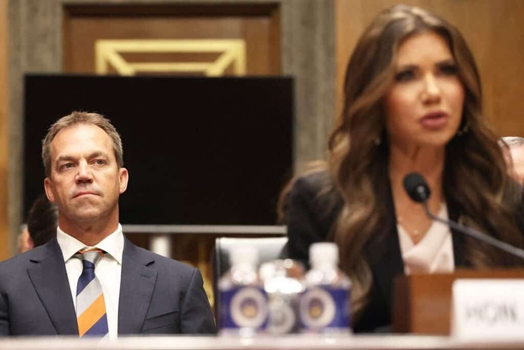 Couple in a tense discussion during a therapy session or hearing.