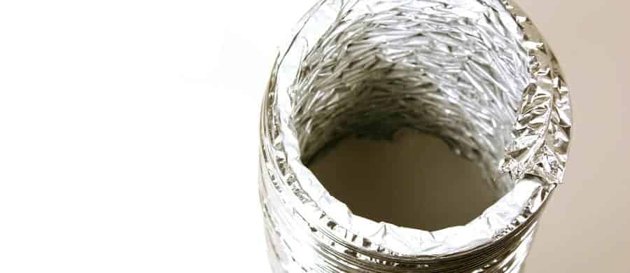 A rolled-up piece of shiny aluminum foil viewed from above against a plain white background.
