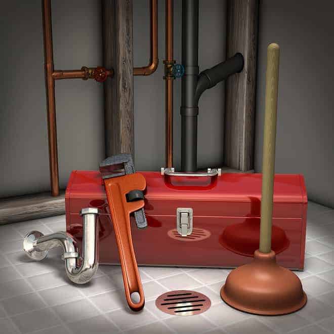 Red toolbox with wrench, pipe, and plunger on tiled floor, near wall with copper plumbing pipes and drain.