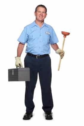 Man in a blue uniform holding a toolbox and a plunger, smiling at the camera.