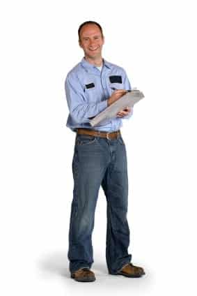 A person in a light blue shirt and jeans holds a clipboard, standing against a white background.