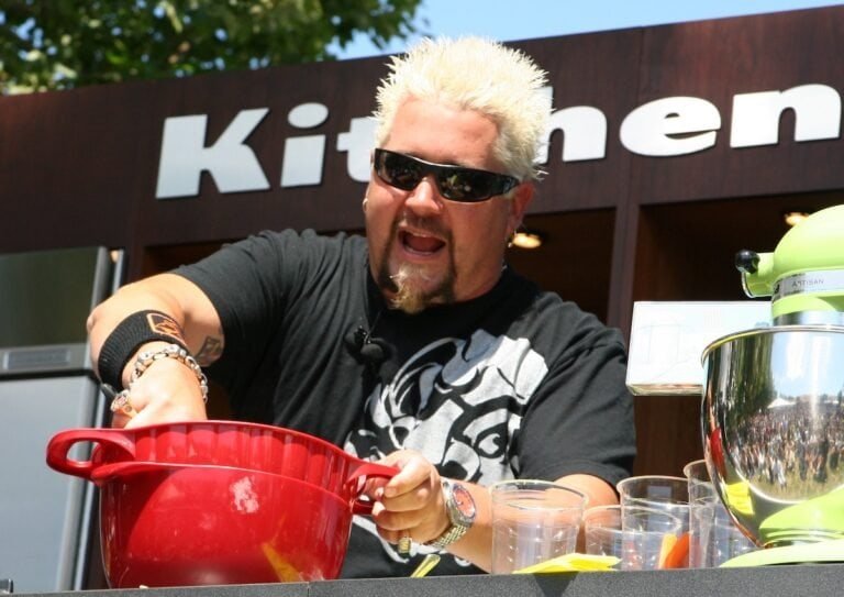 Guy Fieri cooking in front of a store