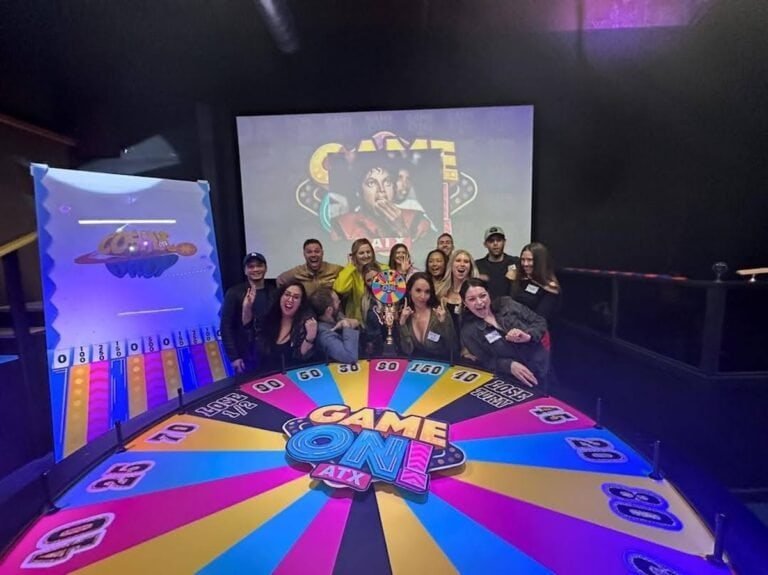 One of the unique group activities in Austin, many friends are posing behind the big wheel at GameOn ATX.