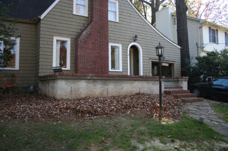 Gorgeous landscaped front yard with brick staircase, vintage street lamp, and mature trees; professional residential landscape design by John Russell Landscape Architect enhancing curb appeal.