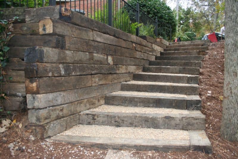Natural stone staircase with retaining wall in landscape design, expertly crafted by John Russell Landscape Architect.