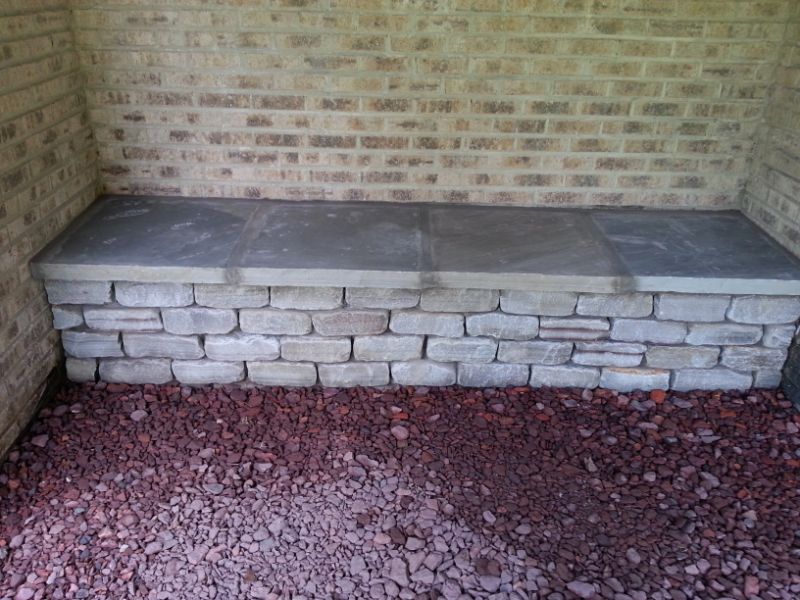 Flagstone and stacked stone outdoor bench by John Russell Landscape Architect, perfect for garden seating and landscape design.
