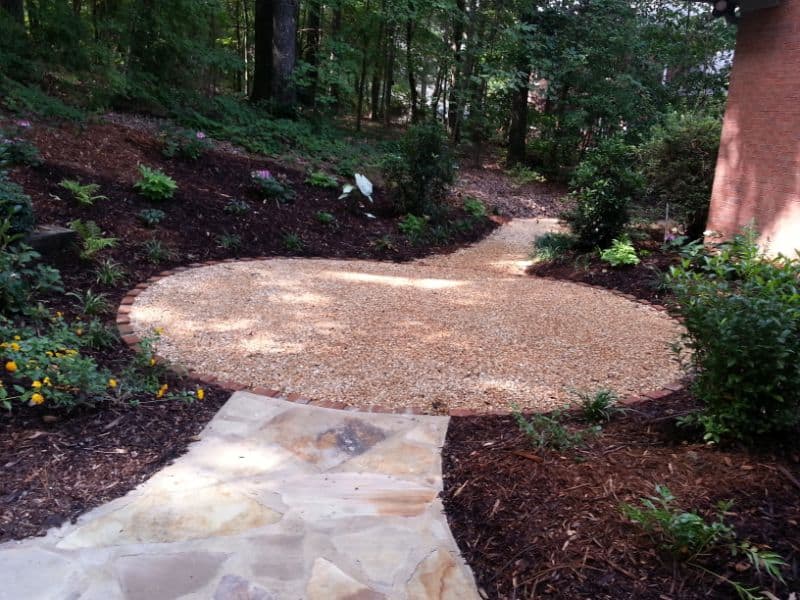 Georgian gravel garden pathway with landscaping by John Russell Landscape Architect, featuring lush plants and natural design.