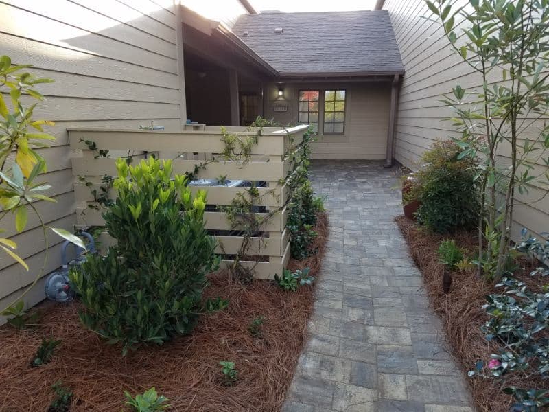 Modern residential backyard landscape design with lush greenery and pathway by John Russell Landscape Architect.