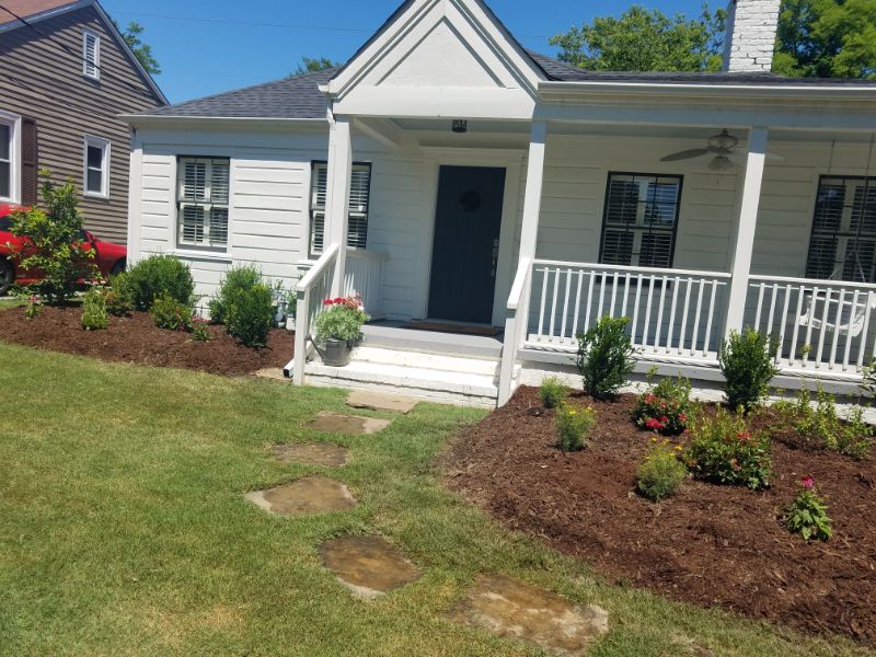 Lush landscaped front yard with pathway and garden beds for residential curb appeal and outdoor living space.
