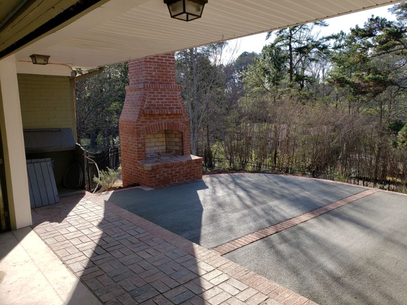 Fireplace outdoor landscape design, brick outdoor fireplace, backyard patio with fireplace, landscape architecture by John Russell Landscape Architect, inviting outdoor space with fireplace and scenic view.