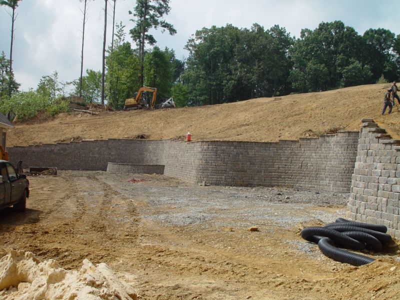 Retaining wall construction for landscape architecture project by John Russell Landscape Architect, showcasing erosion control and landscape design expertise.