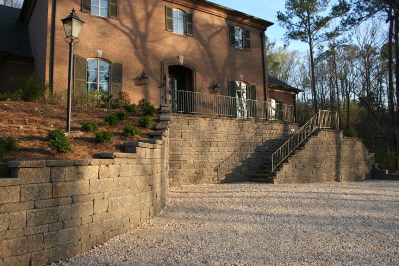 Elegant landscaped terraced garden with stone retaining walls and outdoor staircase designed by John Russell Landscape Architect.